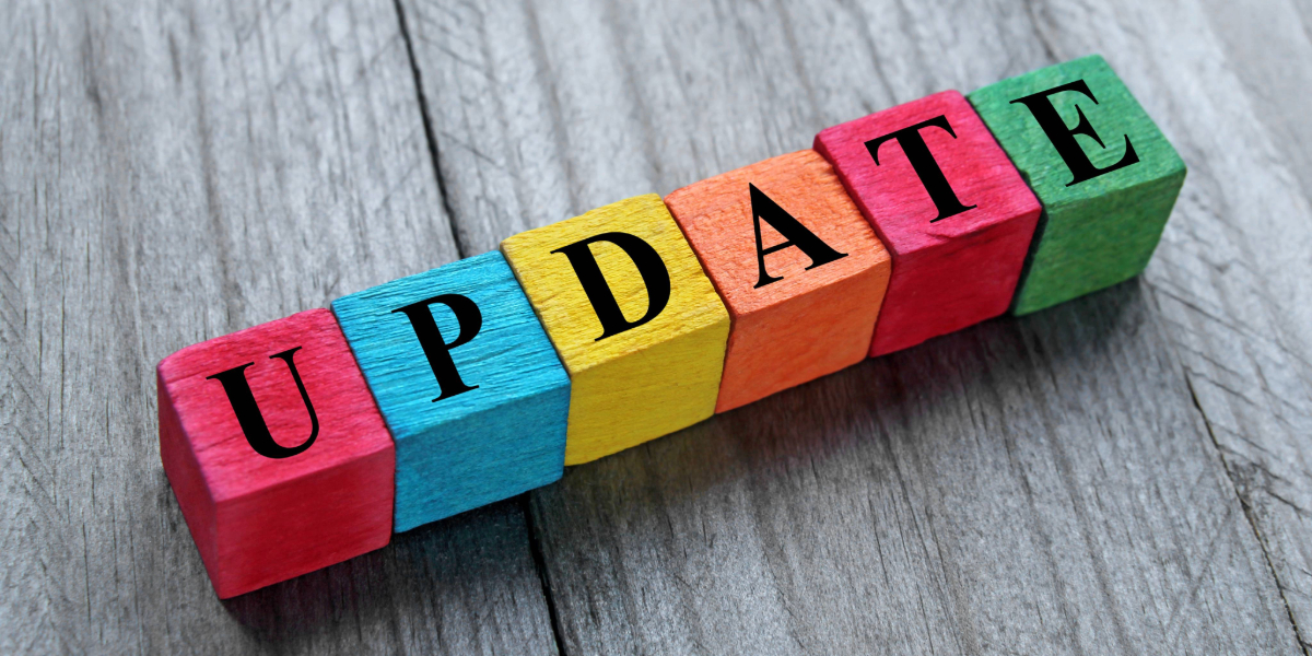 Colorful wooden blocks spelling the word “UPDATE” on a wooden surface